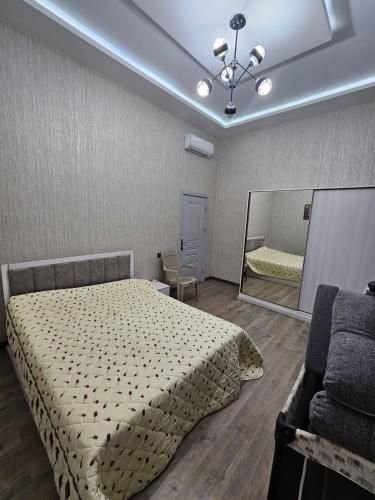 a bedroom with a bed and a large mirror at Mardakan Villa in Baku