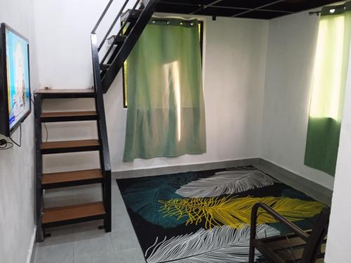 a room with a bunk bed and a staircase at Tiny House Idaman K T dengan Aircond dan Privasi Penuh 1 Bilik Air in Kuala Terengganu