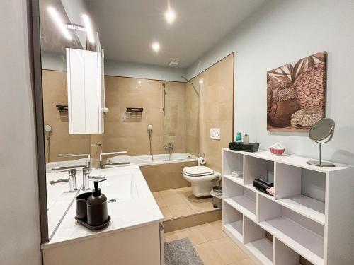 a bathroom with a sink and a toilet and a tub at La tua casa nel cuore di Torino in Turin