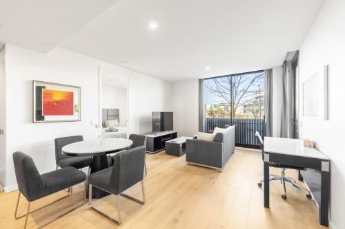 a living room with a table and chairs at Central located 2 bedroom Apartment in Canberra with Parking in Canberra