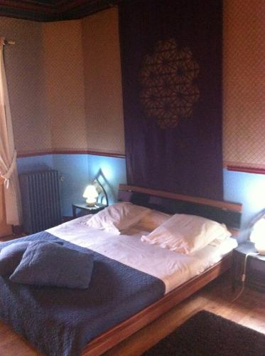 a bedroom with a large bed with a wooden frame at Hotel Residence 18 in Brussels