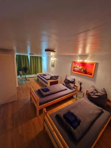 a living room with two beds and a couch at Schöne Wohnung mit Garten nahe schweizer Grenze in Küssaberg