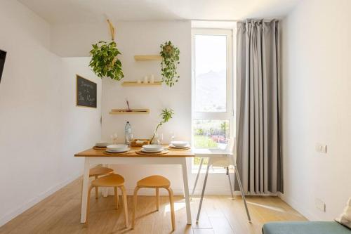 a kitchen with a table and two chairs and a window at Osa Mayor Apartment Bajamar in Bajamar