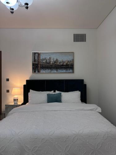 a bedroom with a bed with a painting on the wall at Villa in Yas Island , Abu Dhabi in Yas Island