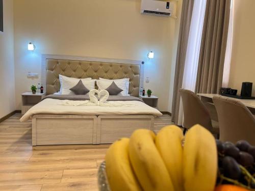 a bedroom with a bed with a bunch of bananas at AKS Hotel in Tashkent
