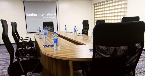 a meeting room with a table with bottles of water at Swiss International The Vistana Lekki Lagos in Ikota
