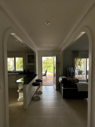 a kitchen and living room with a bed and a couch at The Santander Villa in Orihuela Costa