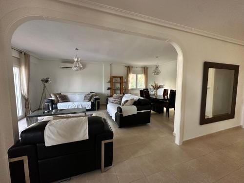 a living room with a bed and a couch at The Santander Villa in Orihuela Costa