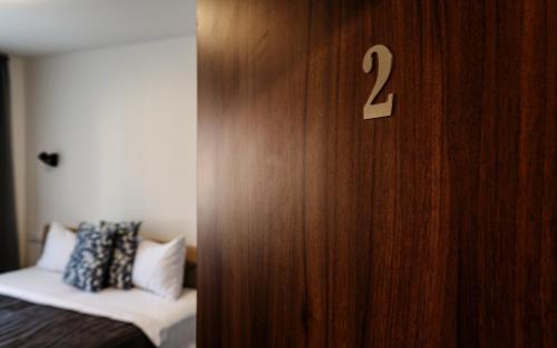 a room with a wooden door with a bed in it at Penzion Terasa Cibulka in Mikulov