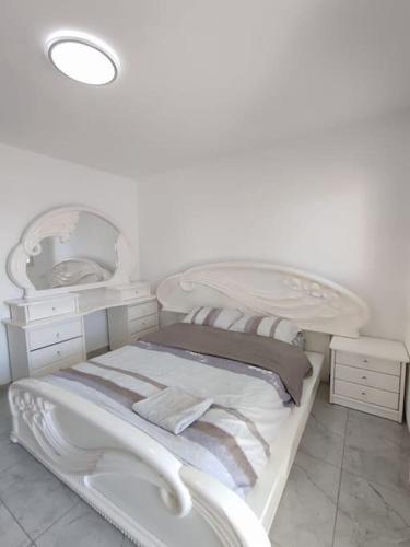 a white room with two beds and a mirror at Apartments by the beach 60-6 in Qiryat H̱ayyim