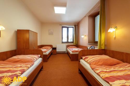 a hospital room with three beds and a window at Areál dobré pohody in Žimrovice