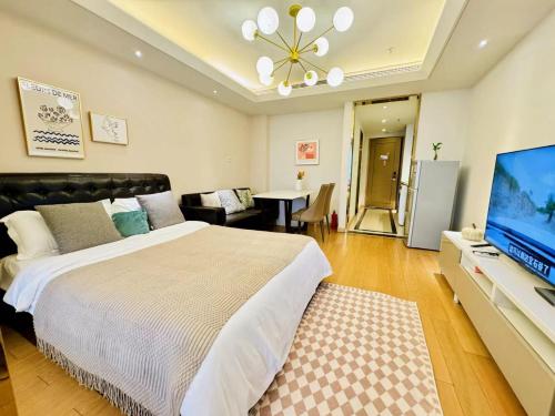 a bedroom with a large bed and a flat screen tv at Shanghai Lerongju Boutique Apartment Metro Line 8 20meter in Shanghai
