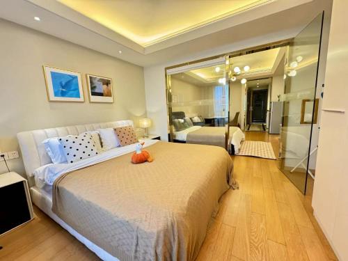 a bedroom with a large bed and a large mirror at Shanghai Lerongju Boutique Apartment Metro Line 8 20meter in Shanghai