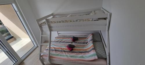 a white bunk bed in a room with a mirror at Summer Park Residence Peljesac in Orebić