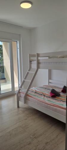 a white bunk bed in a room with a window at Summer Park Residence Peljesac in Orebić