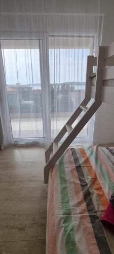 a bed in a room with a large window at Summer Park Residence Peljesac in Orebić