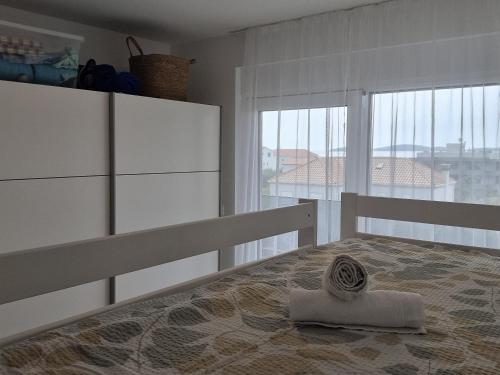 a bedroom with a bed and a large window at Summer Park Residence Peljesac in Orebić