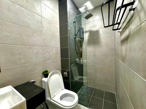 a bathroom with a shower and a toilet and a sink at Premium world-class House-Sea & City View Netflix in Jelutong