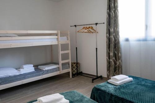 a room with two bunk beds and a closet at Ecumes Sauvages - DODOTERLA in Manapany-les Bains