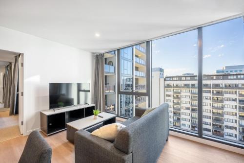 an apartment living room with a large window at Serain Residences on 49 Furzer Street Phillip in Phillip