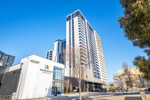 a tall white building with a sign on it at Serain Residences on 49 Furzer Street Phillip in Phillip