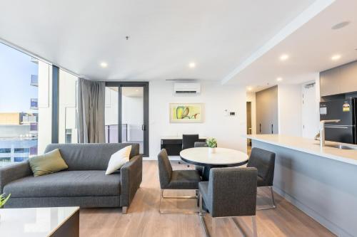 a living room with a couch and a table at Serain Residences on 49 Furzer Street Phillip in Phillip