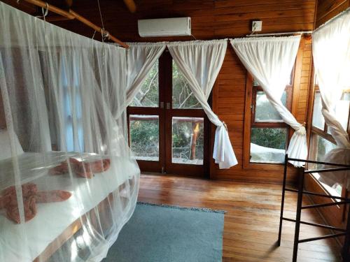 a bedroom with a bed with white mosquito nets at Chicuanga in Chizavane