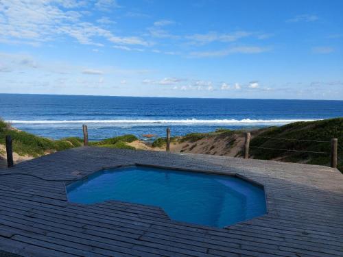 a swimming pool on the roof of a house overlooking the ocean at Chicuanga in Chizavane