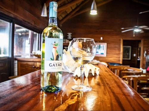 a bottle of wine sitting on a table with a glass at Chicuanga in Chizavane