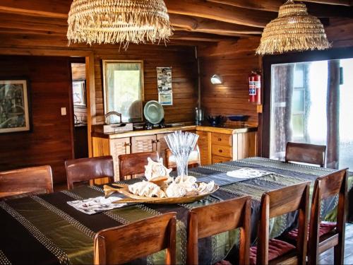 a dining room with a table with chairs and a tableablish at Chicuanga in Chizavane