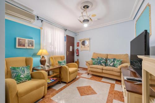 a living room with two couches and a tv at Casa Carmen in Almuñécar