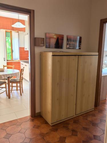 a kitchen and dining room with a wooden cabinet at Residence Dei Fiori in Pietra Ligure
