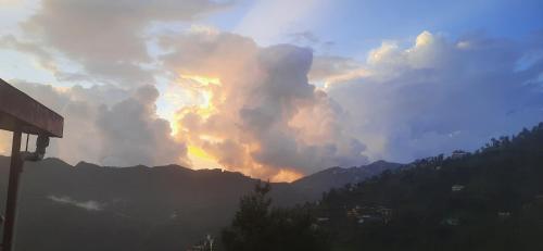 a view of a cloudy sky with a rainbow at Sejal Homestay in Shimla