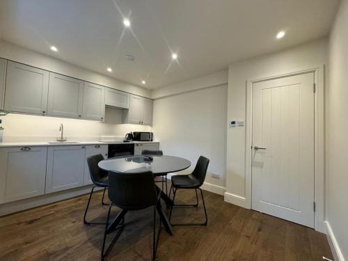 a kitchen with a table and chairs in a room at Townhouse in Weymouth, Dorset in Melcombe Regis