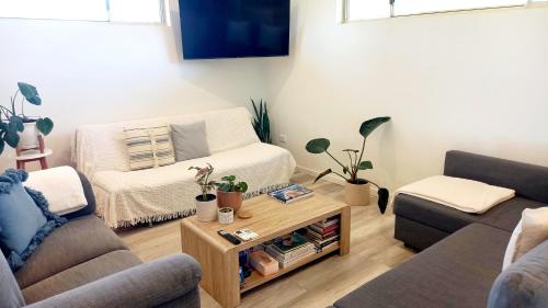 a living room with a couch and a coffee table at Serenity in Style in Kalbarri