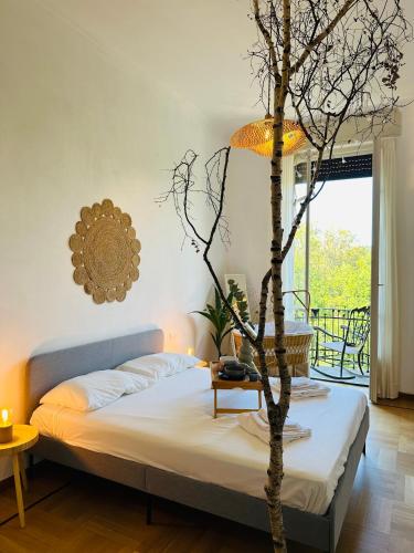 a bedroom with a bed and a tree in it at Liberty House in Turin