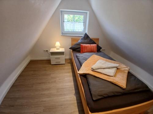 a bedroom with a bunk bed in the attic at Ferienwohnung Ornela in Eggolsheim
