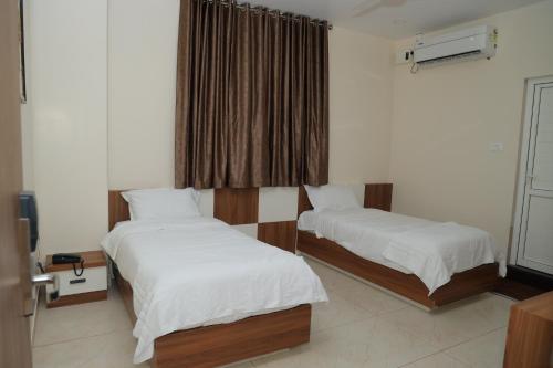 Postel nebo postele na pokoji v ubytování Hotel BR Grand