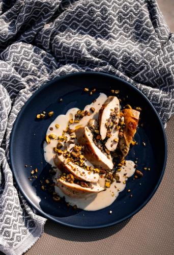 a blue plate with some food on a table at Grands Suites Hotel Residences and Spa in Il-Gżira