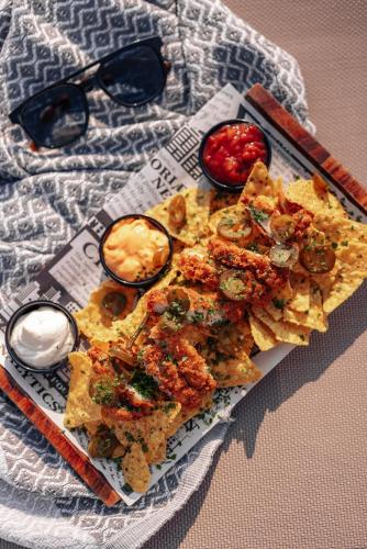 a plate of food on a table with glasses at Grands Suites Hotel Residences and Spa in Il-Gżira
