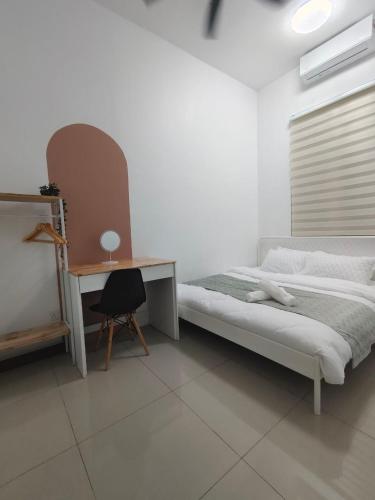 a bedroom with a bed and a desk with a chair at RUMAH ADAM Homestay Bukit Changgang Private Pool in Kampong Kubang Beras