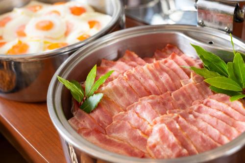 a bunch of ham in a pot on a table at Akita Castle Hotel in Akita