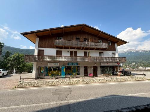 a building on the side of a road at Pelmo Mountain Lodge con bagno turco in Borca di Cadore