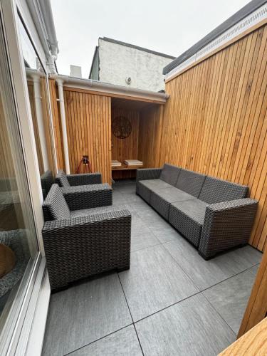 an outdoor patio with two couches and a table at Townhouse in Weymouth, Dorset in Melcombe Regis