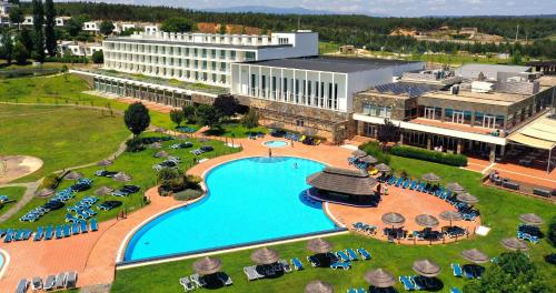 an aerial view of a resort with a large swimming pool at Montebelo Aguieira Lake Resort & Spa in Mortágua