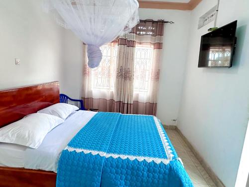 Ein Bett oder Betten in einem Zimmer der Unterkunft Agape House Kisoro