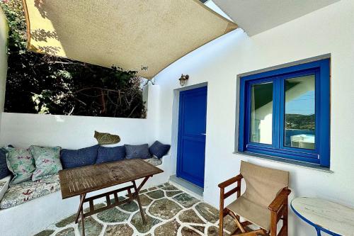 a living room with a couch and a window at Eleni On The Beach in Katapola