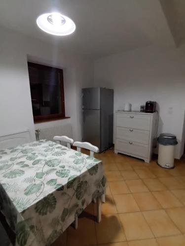 a bedroom with a bed and a dresser and a refrigerator at Matze Hoft 3 étoiles in Niederschaeffolsheim