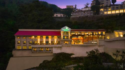 a building with a green sign on top of it at Lemon Tree Resort, Mussoorie in Mussoorie