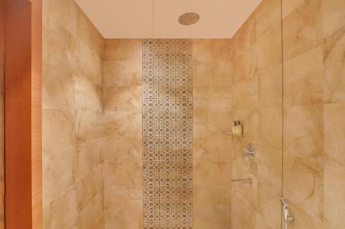 a bathroom with a shower with a glass door at Lemon Tree Resort, Mussoorie in Mussoorie